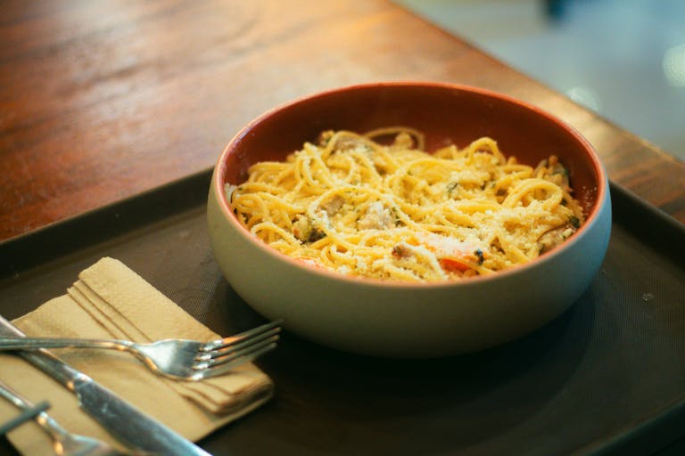 Delicious spaghetti carbonara with cheese served in a cozy setting. Perfect for meal inspiration.